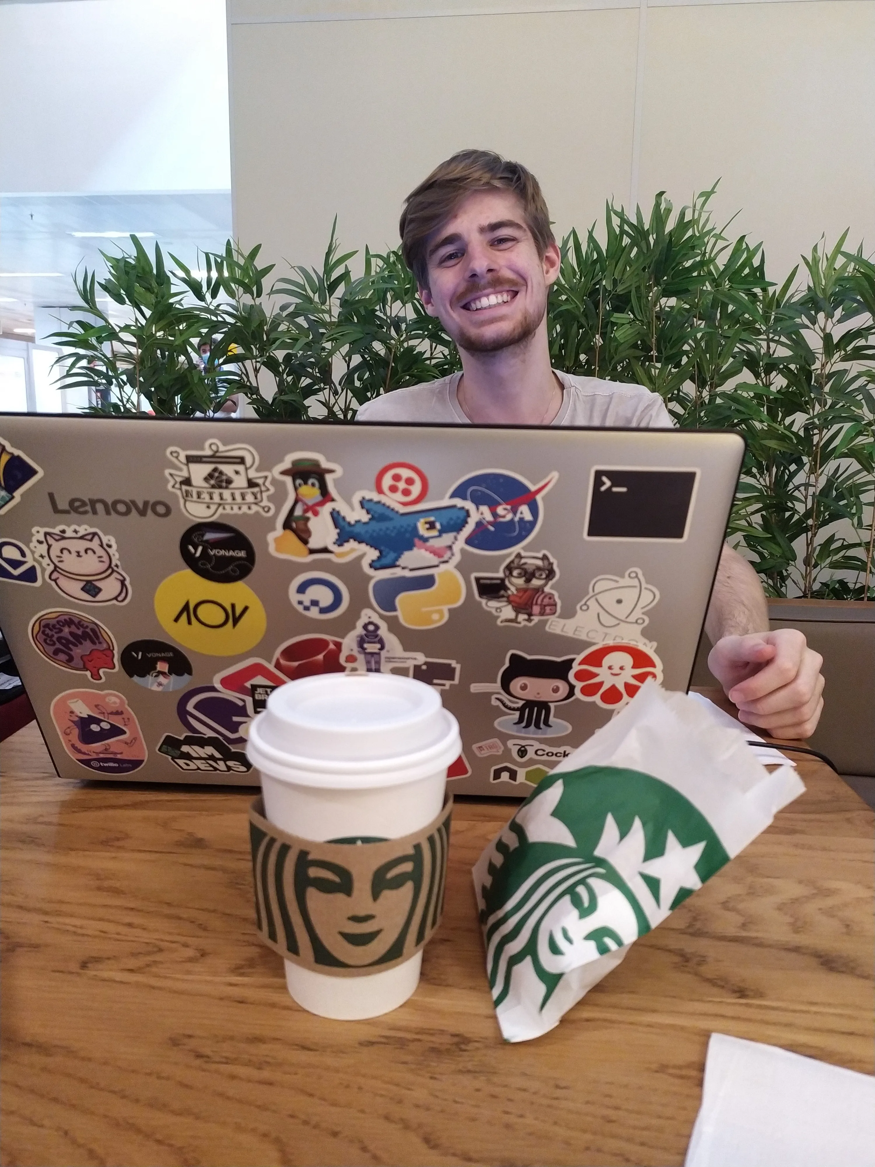 Rafa Audibert working behind a laptop full with stickers